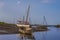 Small boats beached at Morston Creek, Norfolk at low tide