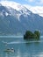 Small boats on Brienzersee Lake, Switzerland, with snow covered Rothorn mountain rising up behind