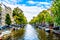 Small boats, cars and bikes lining the Herengracht, or Gentlemen`s Canal, in the historic center of Amsterdam