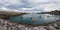 Small boats at the entrance of the fishing port of Bermeo on the coast of Vizcaya on a cloudy day