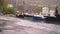 Small boats in a harbor in a town.Rainy weather. Water goes up and reaches the walkway due to the sea level rise