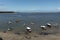 Small boats moored in place where the river meets the sea