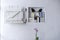 Small bookcase with books in a white wall in the living room with flowers