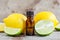 Small bottle of essential citrus lemon and lime oil on the old wooden background. Aromatherapy, spa, herbal medicine ingredients
