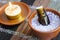 Small bottle of essential oil in the bowl with aroma bath salt and burning candle. Aromatherapy, spa and herbal medicine concept.