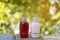 Small bottle of shampoo and conditioner with abstract nature bokeh blur