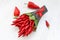 Small bouquet made of hot chilli pepper and the bay leaves on a white wooden table