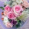 A small bouquet of petite flowers including pink roses.