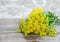 Small bouquet of tansy flowers, close up, wooden background