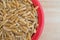 Small bowl filled with Khorasan wheat on table top view