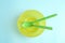 Small bowl and spoons on blue background, top view. Serving baby food