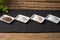 Small bowls with different types of salt, black, pink, flake and seasoned with truffle, on a tablecloth on a rustic table