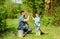 Small boy child help father in farming. Eco farm. father and son in cowboy hat on ranch. use watering can and pot