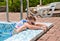 Small boy clambering out of a swimming pool