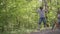 Small boy in climbing equipment in a rope Park. Group of Caucasian children training at boot camp. In the children camp