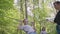 Small boy in climbing equipment in a rope Park. Group of Caucasian children training at boot camp. In the children camp