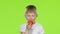 Small boy holding a tomato sniffs it, and shows a thumbs up. Green Screen