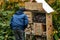 Small boy looking at wooden insects house