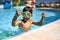 Small boy posing in green swim mask in aquapark