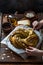 Small boy put pumpkin seeds on babka brioche wreath