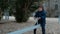 Small boy riding seesaw in playground in winter. Nobody else.