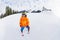 Small boy in ski mask and helmet skiing alone