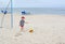 Small boy wants to fight off a soccer ball playing football on the beach sand.