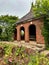 Small brick building with doorway arches at garden