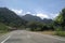 A small bridge across the Banda Aceh â€“ Meulaboh National Road, Indonesia surrounded by hills