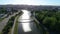 A small bridge across the river, people walk across the pedestrian bridge. Small beautiful bridge over the river