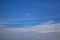 Small bubble flying on blue sky with clouds