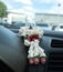 Small buddha amulet with garland on the car console