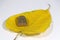 Small buddha amulet on yellow sacred fig or Bodhi leaf on white floor