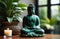 small buddha statue near window among house plants and candles. meditation and spirituality