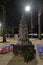 Small Buddhist altar in the park. A table and several plastic chairs. Lantern light