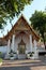 A small Buddhist shrine with a luxuriously decorated roof