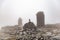 Small built stone structures among stones with moss in the foggy landscaped