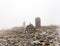 Small built stone structures among stones with moss in the foggy landscaped