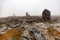 Small built stone towers among stones with moss in the foggy landscape