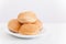 Small buns for hamburgers on white plate