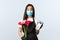 Small business, coronavirus pandemic, orders and shops concept. Excited young store employee, florist in medical mask