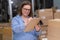 small business owner of online shop, check tracking orders managing product shipments and packaging