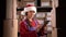 Small Business owner in Santa hat checking stock and inventory with digital tablet in retail warehouse. Worker in online