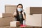 Small business owners, e-commerce and covid-19 preventing virus concept. Happy asian businesswoman in medical mask and