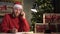 Small business start-up owner Santa Claus works from home in office. Online Christmas sale. a man takes an order on the
