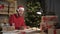 Small business start-up owner Santa Claus works from home in the office. Online Christmas sale. man takes an order by
