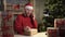 Small business start-up owner Santa Claus works from home office. Online Christmas sale. a man takes an order on the