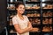 Small Business. Young woman in apron at bakery shop crossed arms posing to camera cheerful