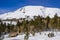 Small Cabin At Base of Snow Covered Mountain