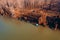 Small cabin floating on river, aerial view